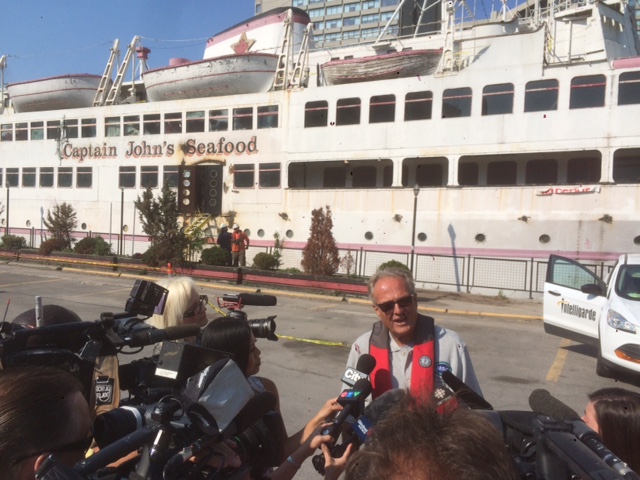 MRC Director of Business Development, Wayne Elliott, addresses the press before the MS Jadran is safely towed from the Toronto Harbour to MRC headquarters in Port Colborne